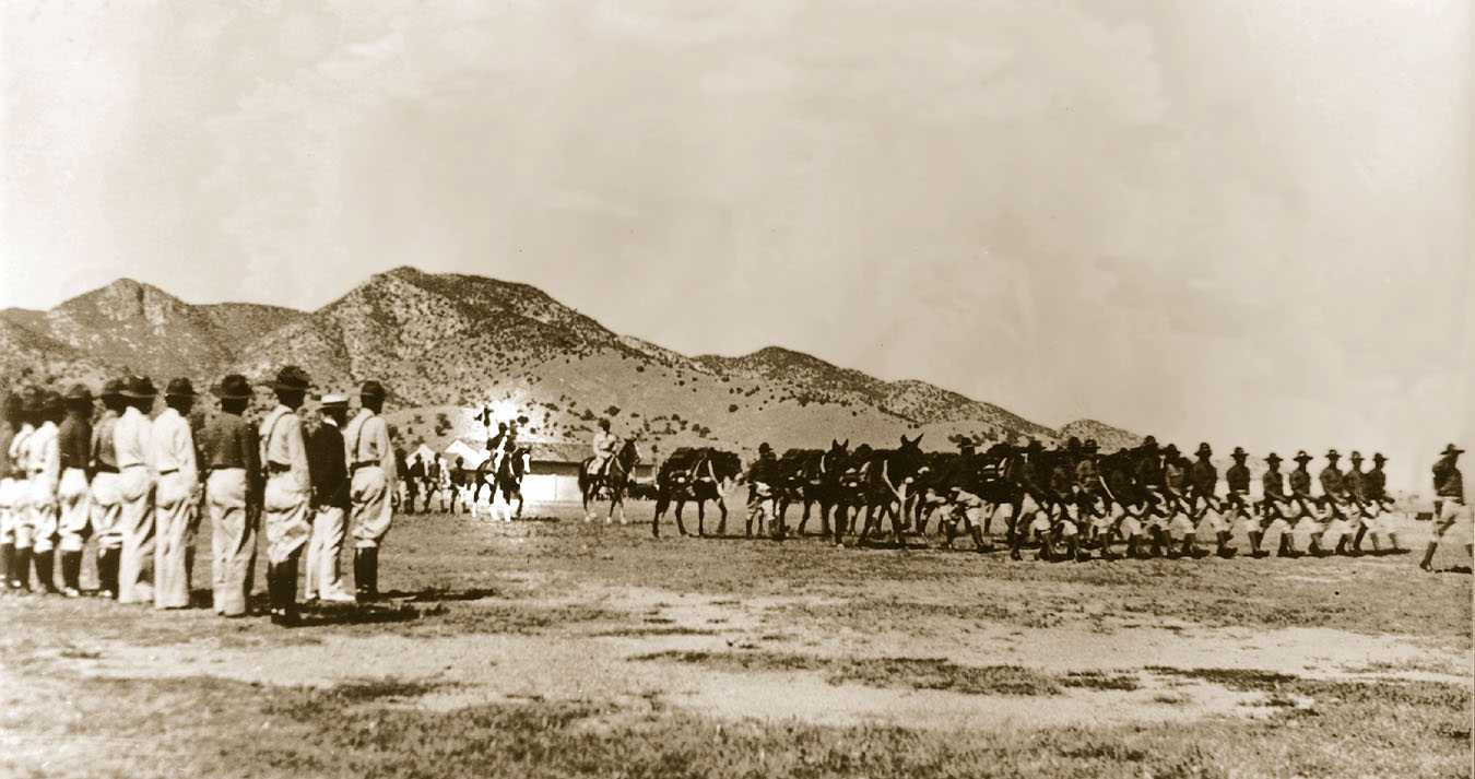 Buffalo Soldiers - The 10th Cavalry in dress blue uniforms passes in review. This picture was taken in 1938 at Fort Huachuca, Arizona. The Trooper carrying the guideon, highlighted, is Valley Coleman. 