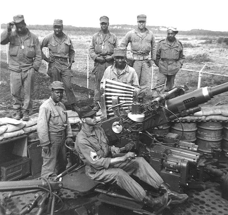 Buffalo Soldiers - Soldiers of the 32nd AAA battery pose while drilling on their four barrel weapon. These soldiers served in Japan.