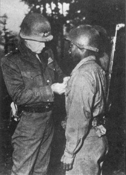General George S. Patton pins the Silver Star on Private Ernest A. Jenkins. Patton told reporters after the ceremony, "The Negro soldiers are damn good soldiers, of whom the nation should be mighty proud." Despite a heroic effort by the all African American 761st Tank Battalion, Patton would not recommend a unit citation for their campaigns in France. In the 1970s the army set the record straight and issued a belated citation.