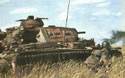 A Pz III advancing with infantry