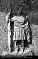 Roman figure carved on rock tomb at the old city of Termessus Turkey copy Renaud Visage