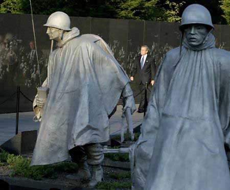 President George W. Bush visits the Korean War Veterans' Memorial in Washington, July 25, 2003. Bush was marking the 50th anniversary of the end of the conflict, which will be commemorated in South Korea on July 27, 2003. Photo by Tim Aubry/Reuters 