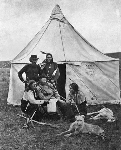 Native Americans - Lieutenant Colonel George Armstrong Custer And Indian Scout Members. A rare print made in the early 1870's in Montana territory, showing General George A. Custer and some of his scouts when the General was in command of troops detailed to guard surveying and building crews constructing the Northern Pacific. The Indian standing by the tent door is thought to be Curly, recorded as the only survivor of the Battle of the Little Bighorn where Custer's entire command was wiped out by the allied Indian tribes under Sitting Bull on June 26, 1876. It is interesting to note, also, that the tent bears the stamp of "N.P.R.R.," undoubtedly part of the equipment furnished Custer by the railroad.