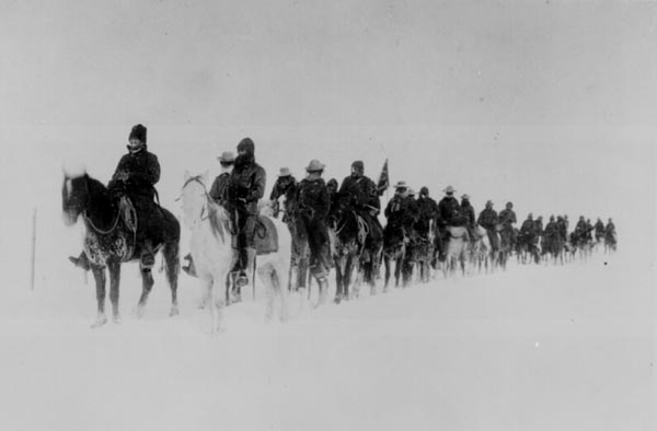 Native Americans - Wounded Knee, "Return of Casey's scouts from the fight at Wounded Knee, 1890--91." Soldiers on horseback plod through the snow. 