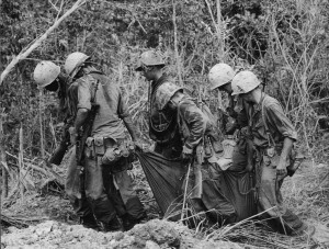 Vietnam War - Soldiers helping buddies tromp through rice paddies