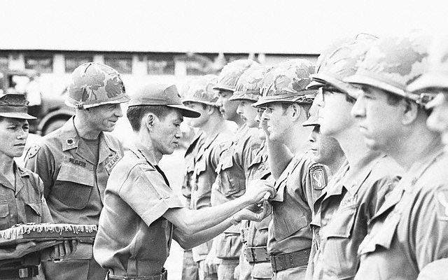 Vietnam War - General Pinning Medal on Soldier, Medal For GI. Da Nang, South Vietnam: South Vietnamese Lt. Gen. Ngo Quang Truong, commander of the First Regional Command, pins medal on a soldier of the Third Battalion, 21st Infantry, the last U.S. combat unit in Vietnam, during the unit's deactivation ceremony at Da Nang August 12, 1972 Looking on is the battalion commander, Lt. Col. Rocco Negris (L). 